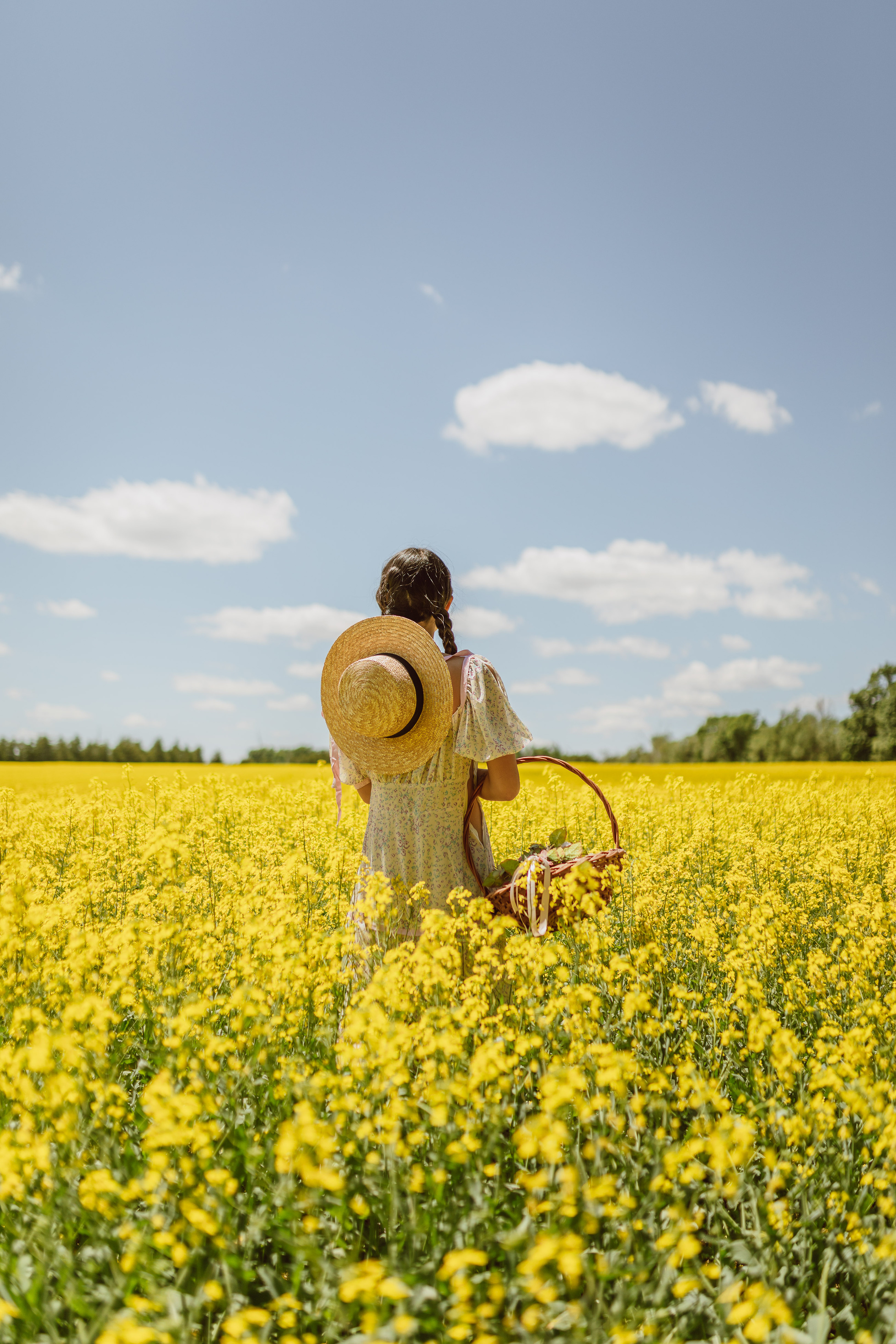 Woman Standing in a Rapeseed Field